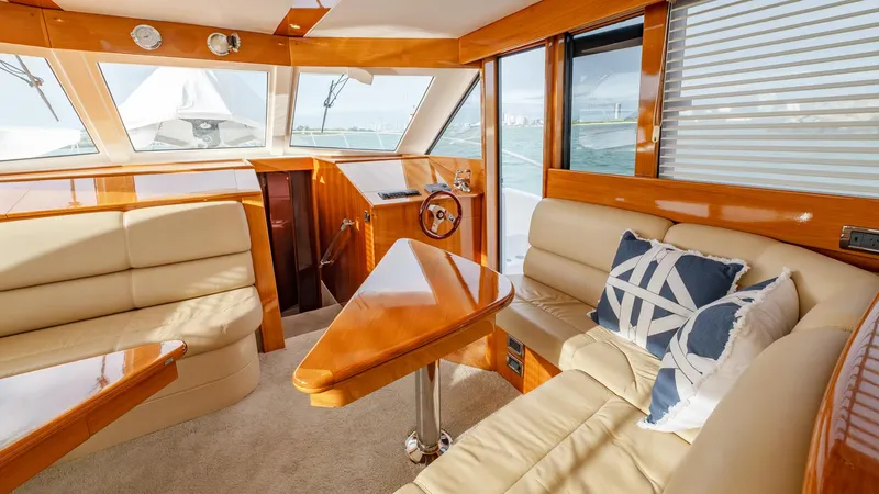 Unchained Freedom Yacht Photos Pics Luxurious interior of 2007 Maritimo M60 Cruising Motor Yacht with plush seating and elegant wood finishes.