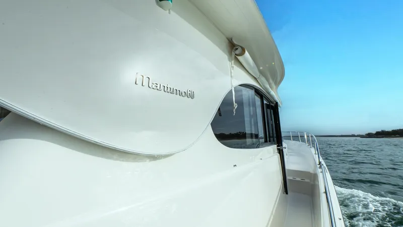 Unchained Freedom Yacht Photos Pics 2007 Maritimo M60 Cruising Motor Yacht on open water, side view.