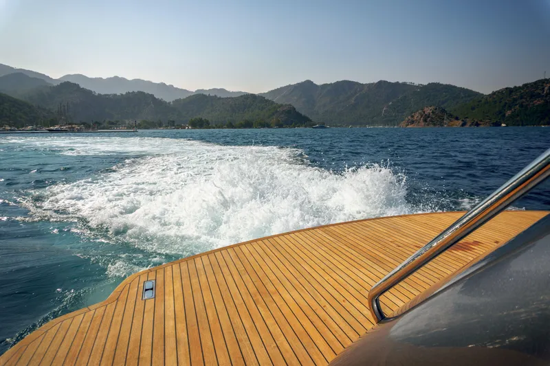 Ginger Yacht Photos Pics Rear view from a 2006 Pershing 115 yacht cruising on a scenic lake.