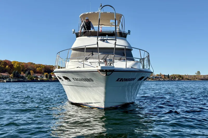 Kronberg Yacht Photos Pics 1990 Neptunus 145 AC yacht on a lake with autumn trees in the background.