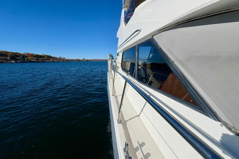 Kronberg Yacht Photos Pics Side view of 1990 Neptunus 145 AC yacht on a calm lake.