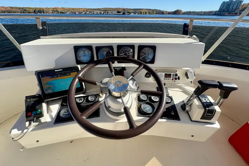 Kronberg Yacht Photos Pics Cockpit of 1990 Neptunus 145 AC yacht with steering wheel and navigation instruments.