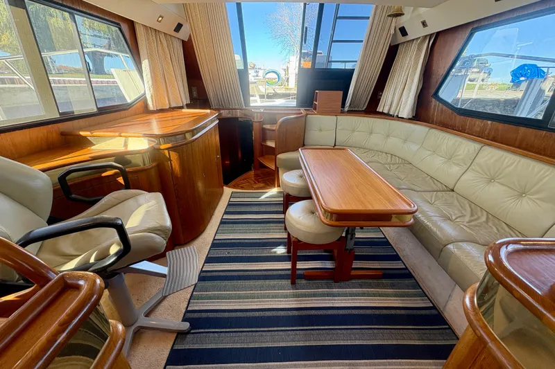 Kronberg Yacht Photos Pics Luxurious interior of 1990 Neptunus 145 AC yacht with leather seating and wooden accents.