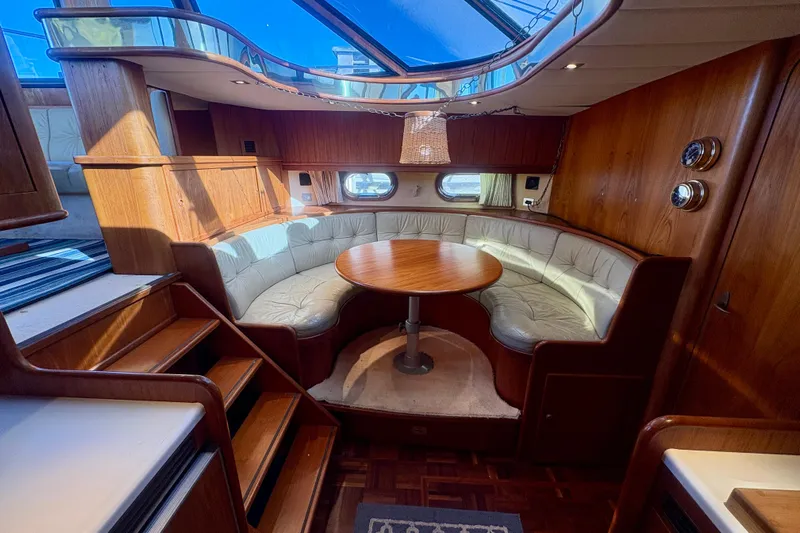 Kronberg Yacht Photos Pics Luxurious 1990 Neptunus 145 AC yacht interior with elegant wood and leather seating.