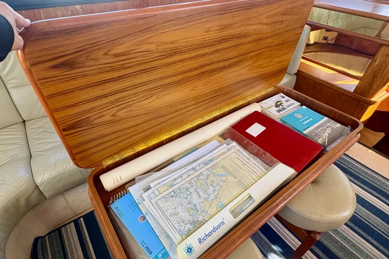 Kronberg Yacht Photos Pics Wooden storage compartment with maps and documents on a 1990 Neptunus 145 AC yacht.