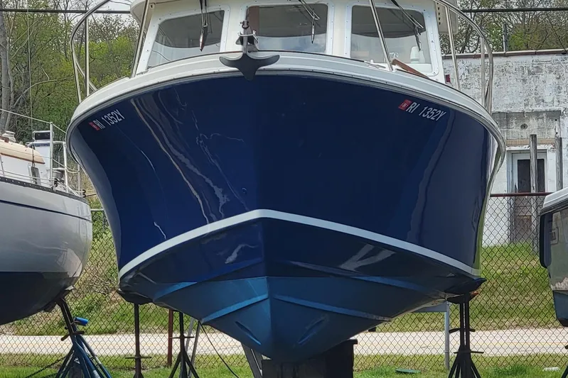  Yacht Photos Pics 2000 Hunt Yachts 29 boat with blue hull on stands, front view.