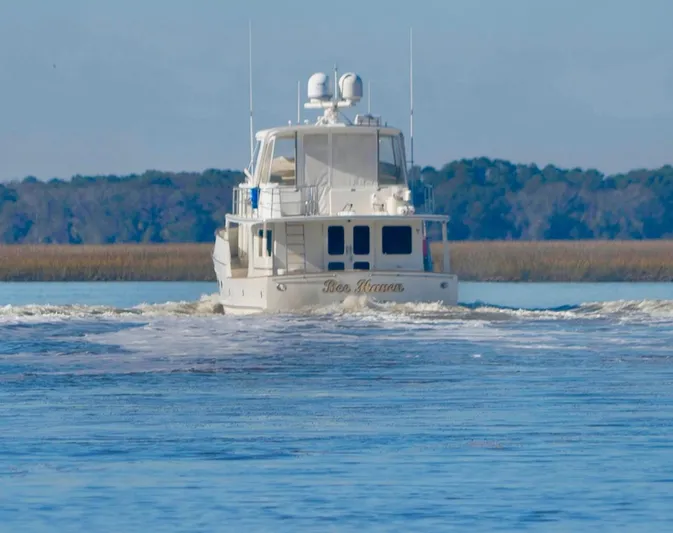 Bee Haven Yacht Photos Pics Fleming 65 Pilothouse Motor Yacht 2006 cruising on a calm waterway.