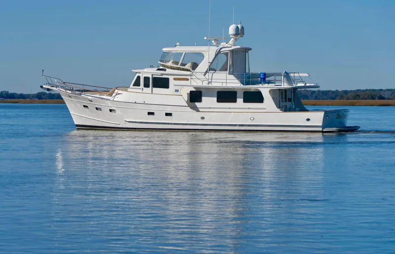 Bee Haven Yacht Photos Pics 2006 Fleming 65 Pilothouse Motor Yacht on calm water.