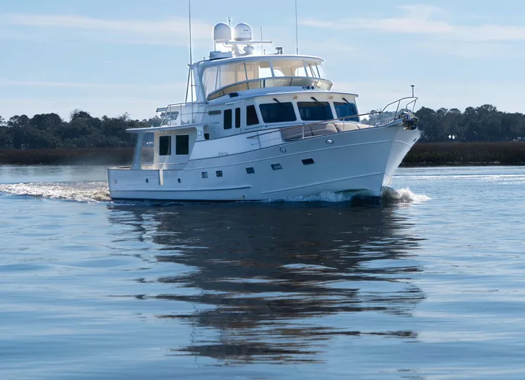 Bee Haven Yacht Photos Pics 2006 Fleming 65 Pilothouse Motor Yacht cruising on calm waters.
