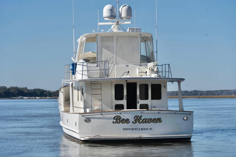 Bee Haven Yacht Photos Pics 2006 Fleming 65 Pilothouse Motor Yacht on calm water, rear view.
