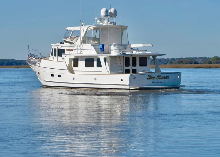 Bee Haven Yacht Photos Pics 2006 Fleming 65 Pilothouse Motor Yacht cruising on calm waters.