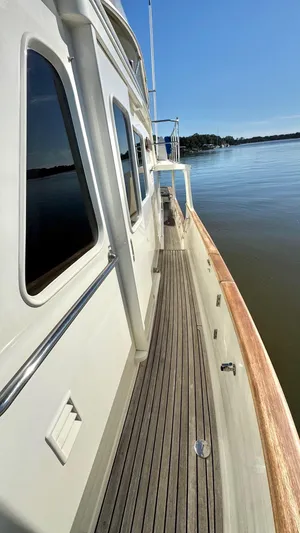 Bee Haven Yacht Photos Pics Side deck of 2006 Fleming 65 Pilothouse Motor Yacht on calm water.