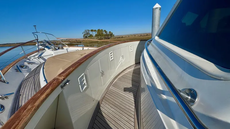 Bee Haven Yacht Photos Pics 2006 Fleming 65 Pilothouse Motor Yacht deck with wooden railings and scenic water view.