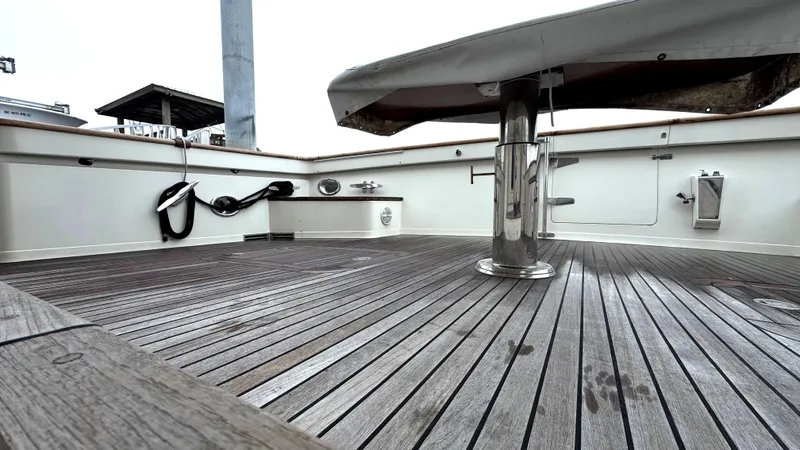 Bee Haven Yacht Photos Pics Fleming 65 Pilothouse Motor Yacht 2006 deck with wooden flooring and covered table.