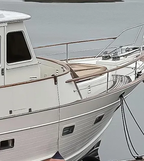 Bee Haven Yacht Photos Pics 2006 Fleming 65 Pilothouse Motor Yacht docked on calm water.