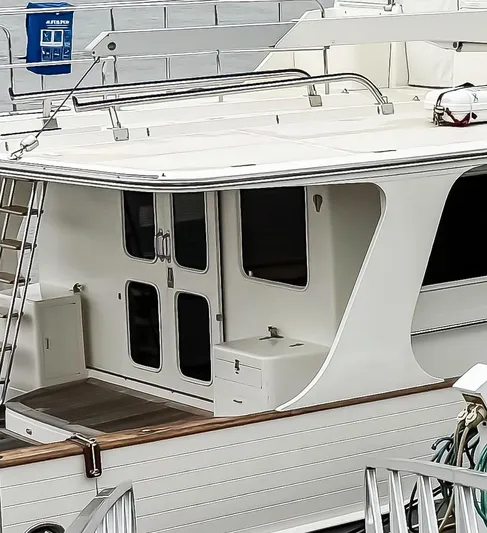 Bee Haven Yacht Photos Pics 2006 Fleming 65 Pilothouse Motor Yacht docked, showcasing rear deck and entryway.