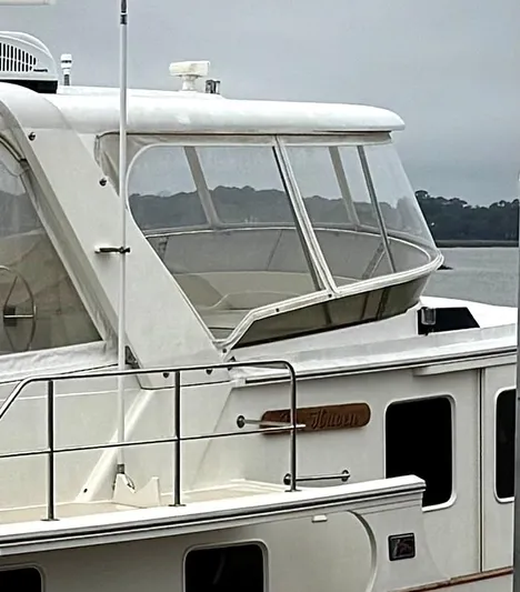 Bee Haven Yacht Photos Pics 2006 Fleming 65 Pilothouse Motor Yacht, side view, docked on a cloudy day.