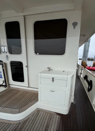 Bee Haven Yacht Photos Pics 2006 Fleming 65 Pilothouse Motor Yacht deck with sink and storage.