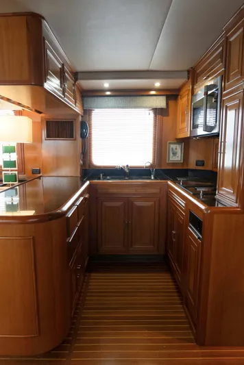 Bee Haven Yacht Photos Pics Luxurious 2006 Fleming 65 Pilothouse Motor Yacht kitchen with wood cabinetry and modern appliances.