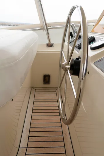 Bee Haven Yacht Photos Pics 2006 Fleming 65 Pilothouse Motor Yacht helm with wooden flooring and steering wheel.