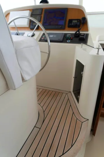 Bee Haven Yacht Photos Pics Pilothouse interior of 2006 Fleming 65 Motor Yacht with steering wheel and navigation equipment.