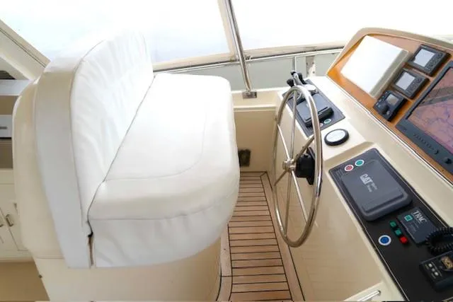 Bee Haven Yacht Photos Pics Pilothouse interior of 2006 Fleming 65 Motor Yacht with steering wheel and navigation equipment.