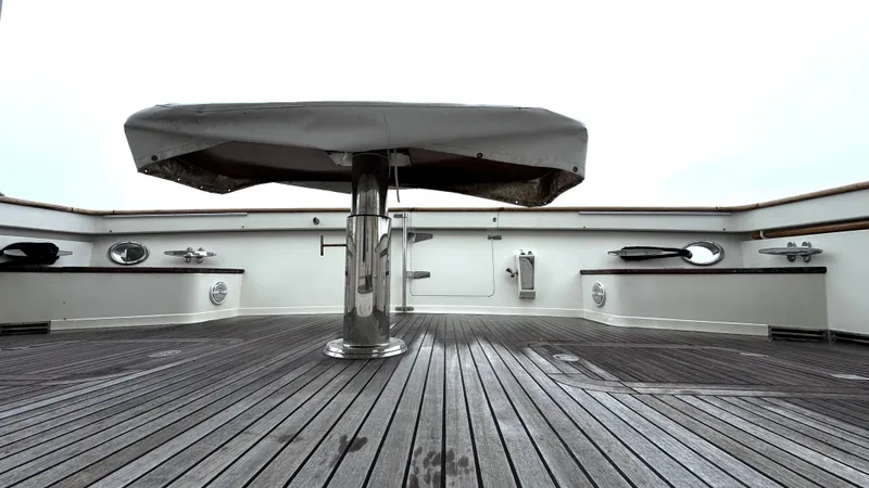 Bee Haven Yacht Photos Pics Fleming 65 Pilothouse Motor Yacht 2006 deck with covered table and wooden flooring.