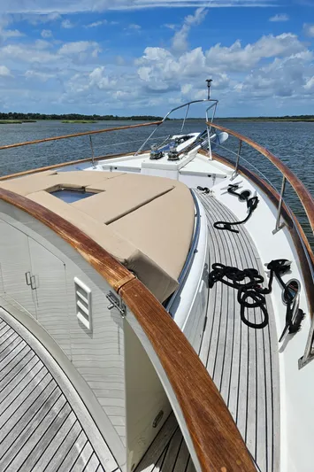 Bee Haven Yacht Photos Pics 2006 Fleming 65 Pilothouse Motor Yacht on calm water under blue sky.