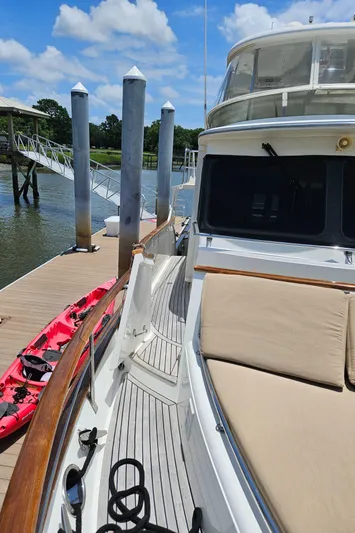 Bee Haven Yacht Photos Pics 2006 Fleming 65 Pilothouse Motor Yacht docked, featuring spacious deck and seating area.