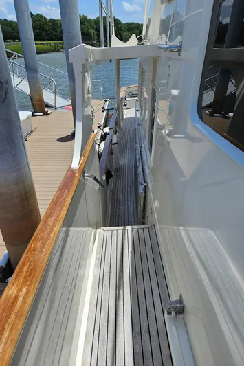 Bee Haven Yacht Photos Pics Side deck of 2006 Fleming 65 Pilothouse Motor Yacht docked by water.