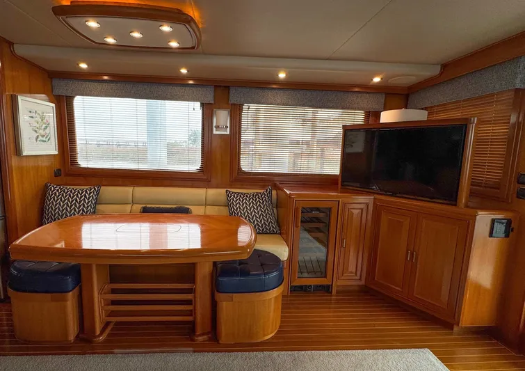 Bee Haven Yacht Photos Pics Luxurious interior of 2006 Fleming 65 Pilothouse Motor Yacht with dining area and TV.