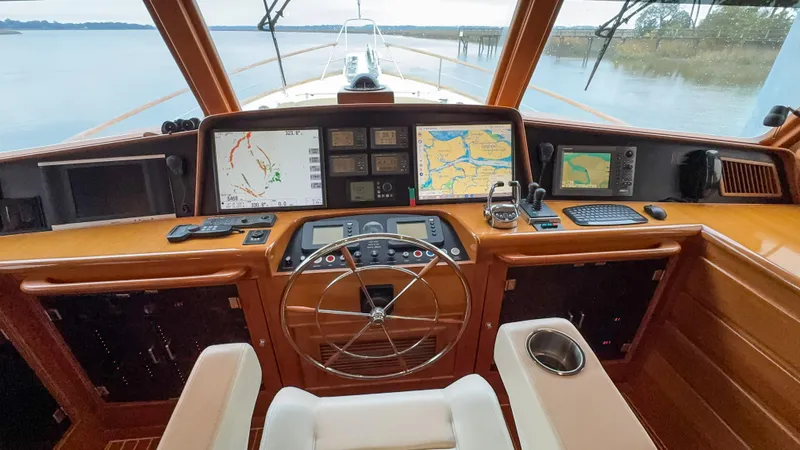 Bee Haven Yacht Photos Pics Pilothouse of 2006 Fleming 65 Motor Yacht with navigation screens and steering wheel.