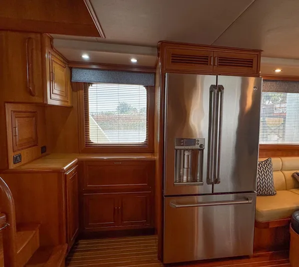 Bee Haven Yacht Photos Pics Interior of 2006 Fleming 65 Pilothouse Motor Yacht with modern kitchen and stainless steel fridge.