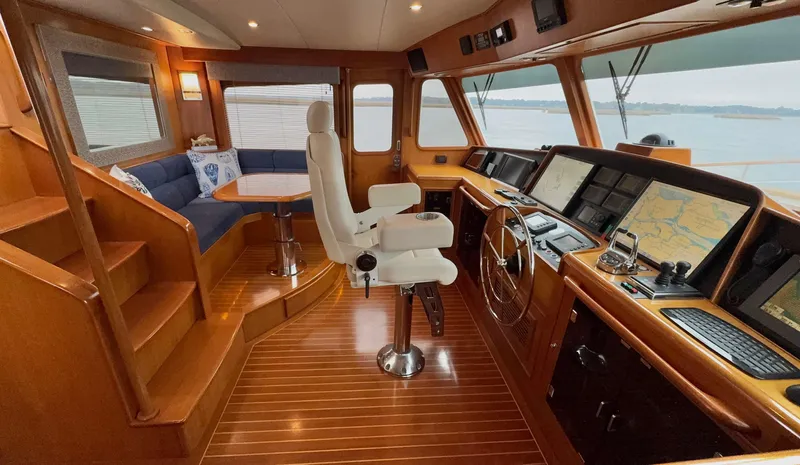 Bee Haven Yacht Photos Pics Luxurious 2006 Fleming 65 Pilothouse Motor Yacht interior with navigation equipment and seating area.