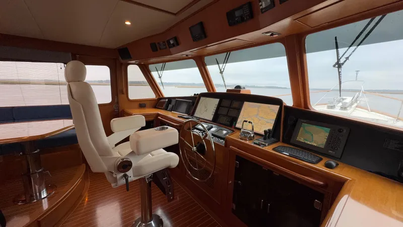 Bee Haven Yacht Photos Pics Pilothouse interior of 2006 Fleming 65 Motor Yacht with navigation equipment and captain's chair.