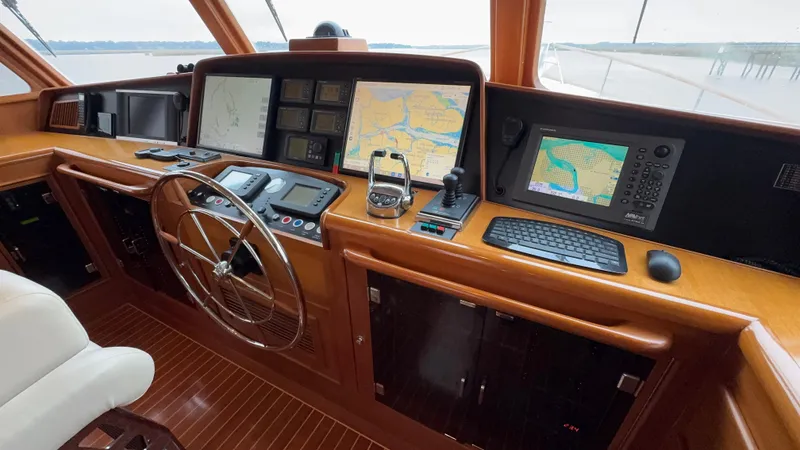 Bee Haven Yacht Photos Pics Pilothouse of 2006 Fleming 65 Motor Yacht with navigation screens and steering wheel.