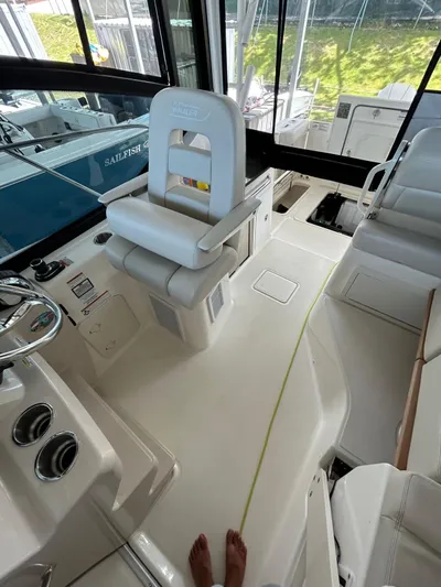  Yacht Photos Pics 2022 Boston Whaler 325 Conquest interior with helm and seating area.