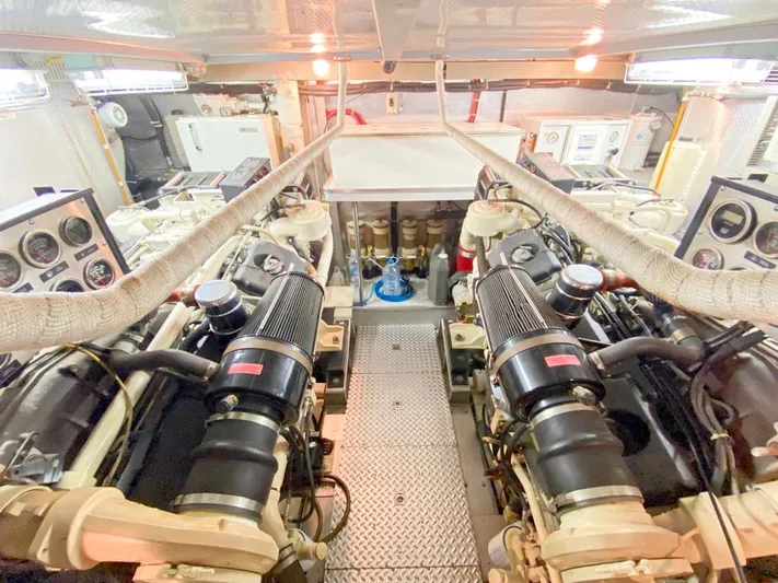 Curiosity Yacht Photos Pics Engine room of 2001 Elegance 82 S yacht, featuring dual engines and control panels.