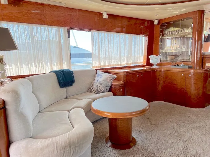 Curiosity Yacht Photos Pics Luxurious yacht interior with plush seating, wooden accents, and elegant decor, Elegance 82 S, 2001.