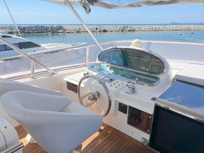 Curiosity Yacht Photos Pics Elegant 2001 Elegance 82 S yacht helm with white seating and ocean view.
