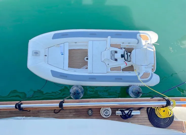 Curiosity Yacht Photos Pics Top view of a 2001 Elegance 82 S boat docked on calm water.