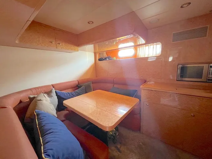 Curiosity Yacht Photos Pics Luxurious 2001 Elegance 82 S yacht interior with cozy dining area and modern amenities.