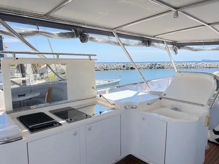 Curiosity Yacht Photos Pics Luxury yacht Elegance 82 S, 2001 model, featuring an outdoor kitchen with sea view.