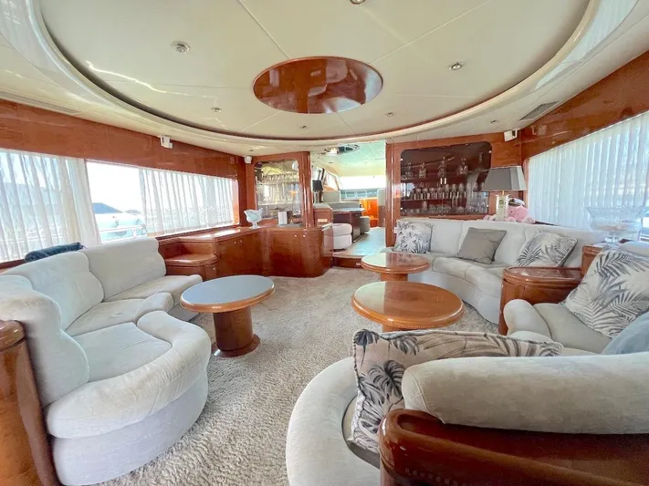 Curiosity Yacht Photos Pics Luxurious yacht interior with plush seating, wooden accents, and elegant decor, Elegance 82 S, 2001 model.