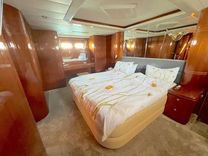 Curiosity Yacht Photos Pics Luxurious bedroom interior on 2001 Elegance 82 S yacht with elegant wood paneling.