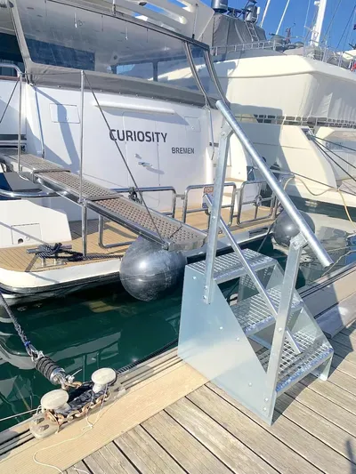 Curiosity Yacht Photos Pics Luxury yacht Elegance 82 S, 2001 model, docked with boarding stairs and fenders.
