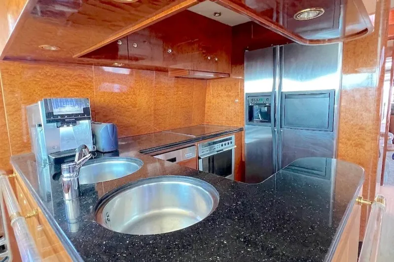 Curiosity Yacht Photos Pics Luxurious yacht kitchen with modern appliances, sleek countertops, and wood paneling, Elegance 82 S, 2001.