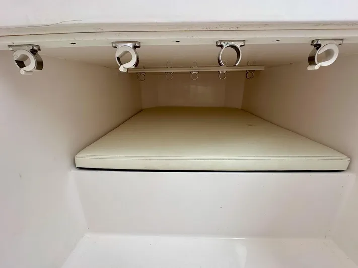  Yacht Photos Pics Interior storage compartment of 2021 Streamline 35CC boat with rod holders and cushioned surface.