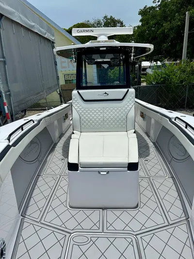  Yacht Photos Pics 2021 Streamline 35CC boat interior with cushioned seating and Garmin equipment.