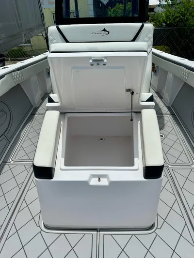  Yacht Photos Pics Open storage compartment on 2021 Streamline 35CC boat, featuring cushioned seating and modern design.